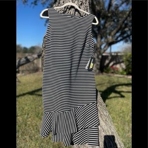 Black & white sleeveless dress with asymmetrical ruffle.